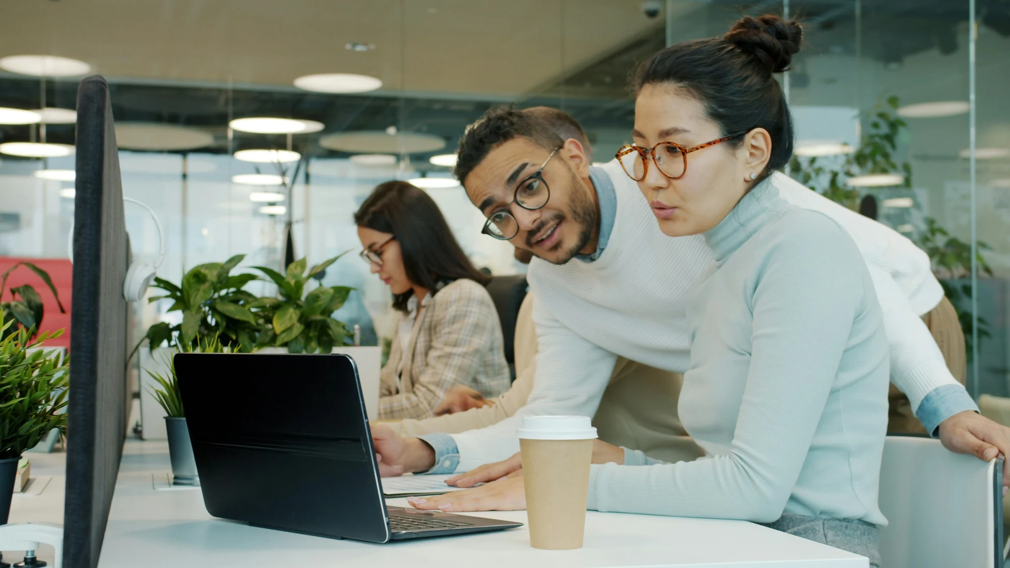 A marketing team reviewing results together on a laptop